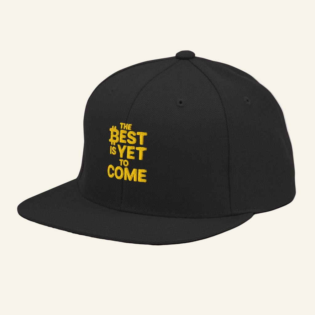 Black cap with yellow text 'The Best is Yet to Come' on a white background