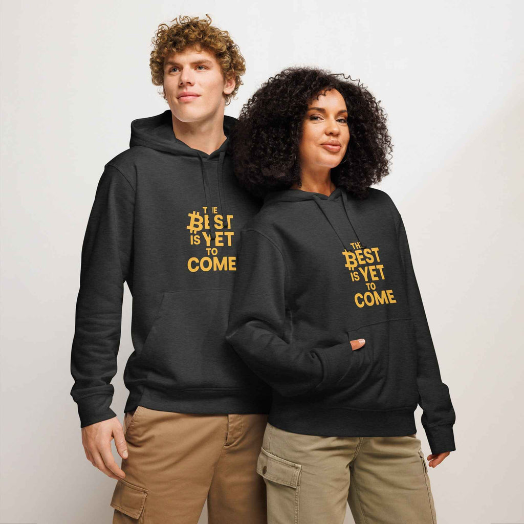 Two people wearing black hoodies with yellow text on a plain background